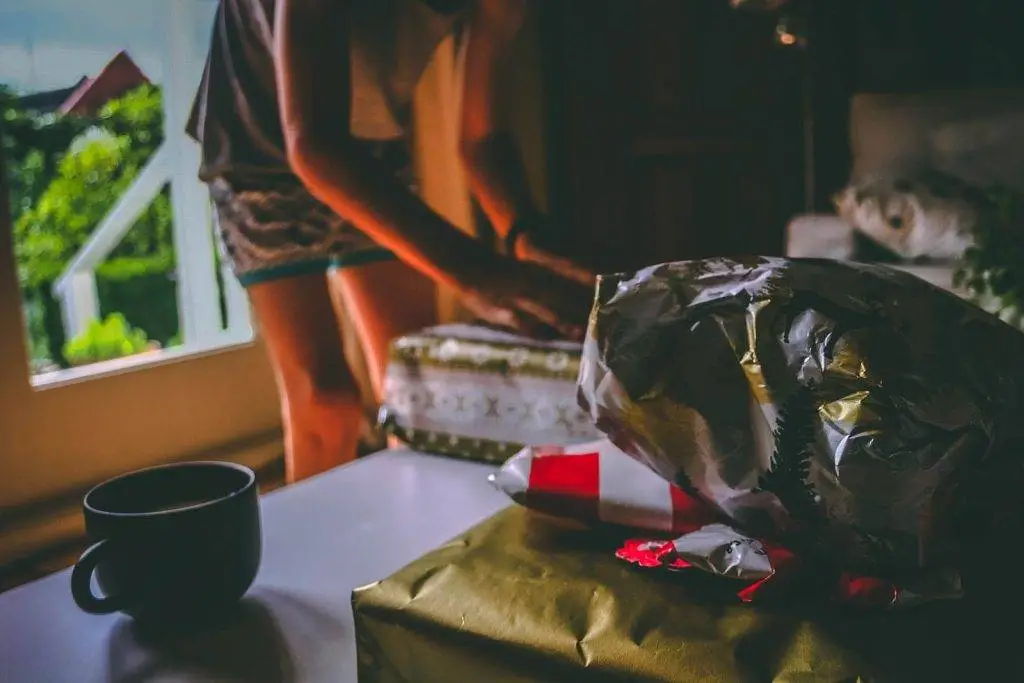 A warm indoor scene featuring gifts and a cup of coffee, set in a cozy room.